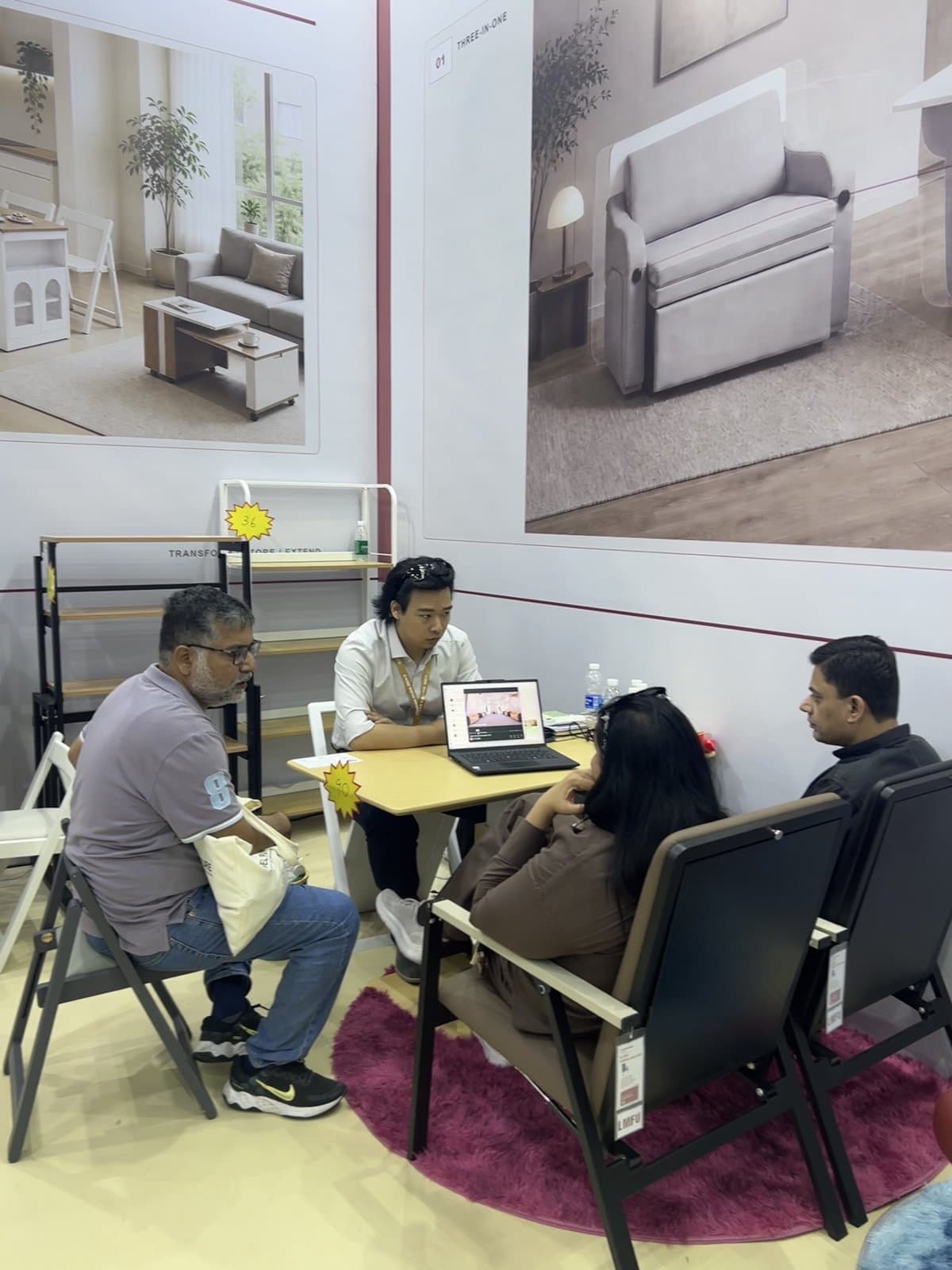 A seated discussion with visitors at the booth.