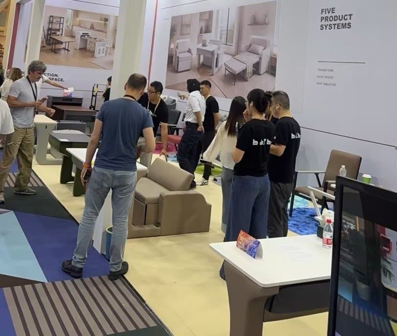 Visitors exploring the furniture displays at the LMFU stand.